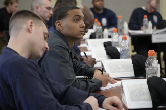 Correctional Officers paying attention to a lecture