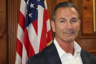 Photo of Dean Isabella with American flag